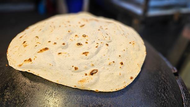 istock Handmade spinning Naan flatbreads for healthy kebab wraps — spiced beef, chicken, fresh herbs, street food, Middle Eastern and Indian traditional night market cooking process 2220358842