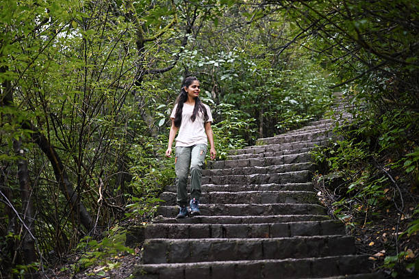istock Young Woman Hiking Down Stone Steps in a Forest 2220359280