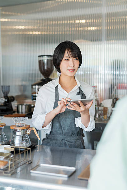 istock Female staff taking orders at a cafe 2220359532