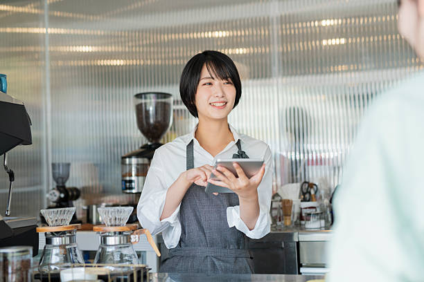 istock Female staff taking orders at a cafe 2220360080