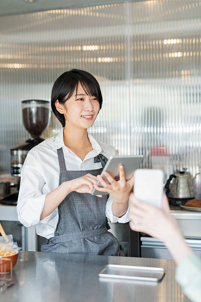 istock Woman showing her smartphone to staff 2220361032
