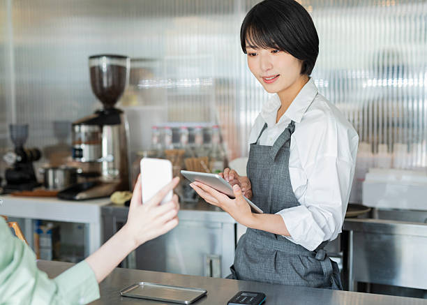 istock Woman showing her smartphone to staff 2220361453