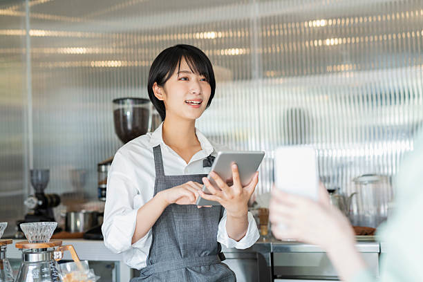 istock Woman showing her smartphone to staff 2220361880