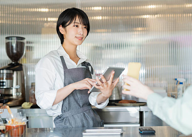 istock Woman showing her smartphone to staff 2220361933