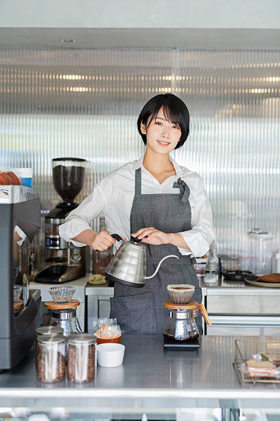 Female staff brewing coffee