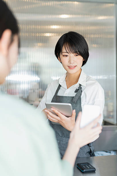 istock Woman showing her smartphone to staff 2220362208