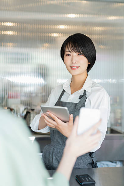istock Woman showing her smartphone to staff 2220362290