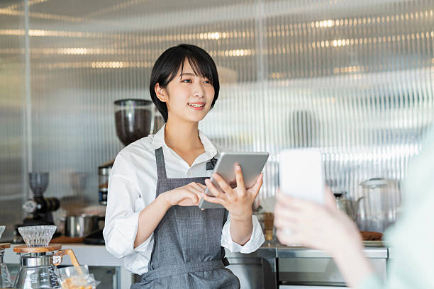 istock Woman showing her smartphone to staff 2220362428