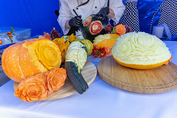 An array of meticulously sculpted fruits and vegetables like roses, pumpkins, zucchinis, and more, elegantly displayed on wooden platters, creating a visually stunning feast.