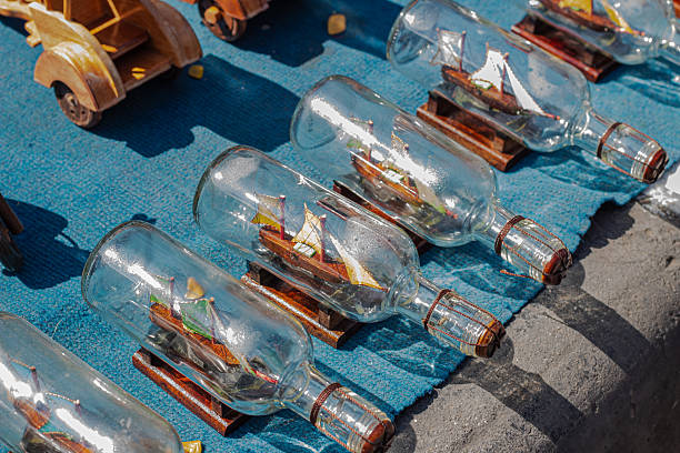 Collection of detailed miniature boats displayed inside bottles