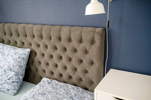 istock Modern upholstered headboard close-up with pillows in cozy bedroom 2220365713