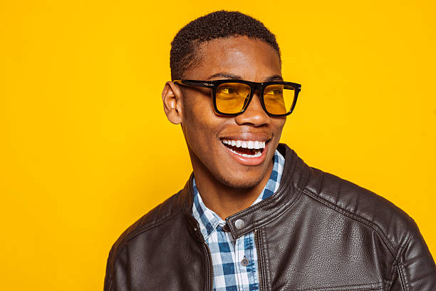 istock Happy stylish man smiling and looking away on yellow background 2220369272