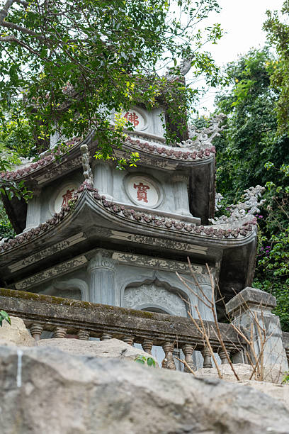 istock A beautiful pagoda is perched upon a rocky hill, surrounded by lush trees 2220369400