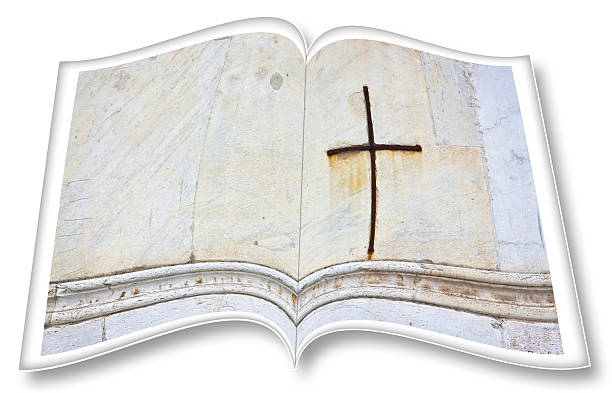 istock Opened photobook on withe background with christian iron cross - concept image 2220375237