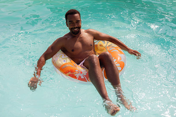 istock Black Man Chilling in Pool on Hot Summer Day 2220375984
