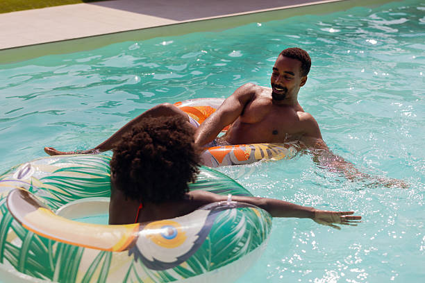 istock Happy Young Couple Enjoying Pool Together 2220376025