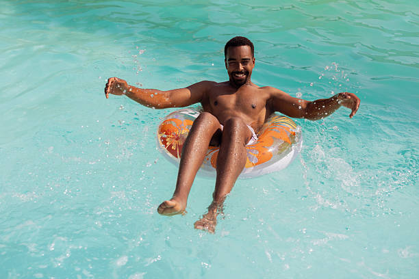 istock Black Man Chilling in Pool on Hot Summer Day 2220376035