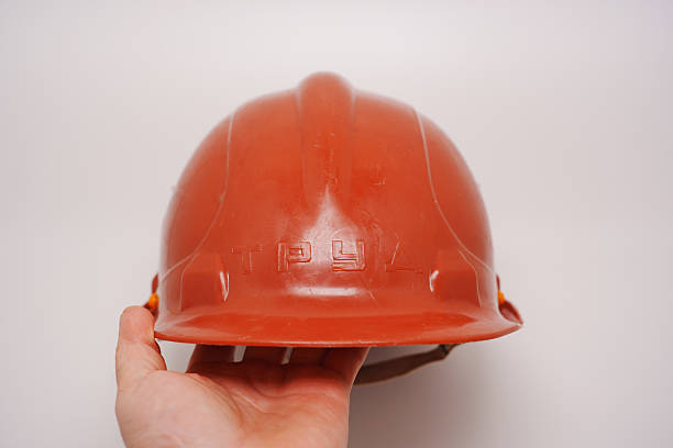 istock Safety helmet held in hand, showcasing protective gear and design details 2220376100