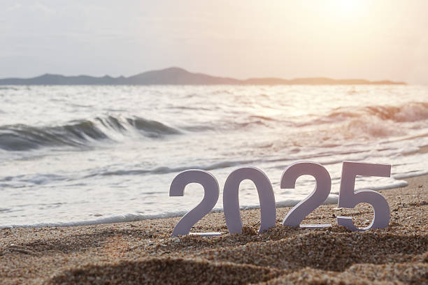 istock number 2025 on sandy beach with sea ripple wave at background with golden sun light during sunset time 2220378663
