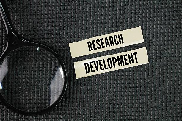 istock Magnifying glass with the word Research and development. work directed towards the innovation, introduction, and improvement of products and processes. 2220379205
