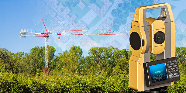Red and white tower crane surrounded by nature and 3D rendering of a geodesic device, called Total Station, used for the survey of topographic maps and topographical survey - concept image with a cadastral map on foreground