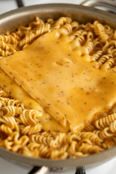 Adding cheddar cheese on pan-fried noodle ramen