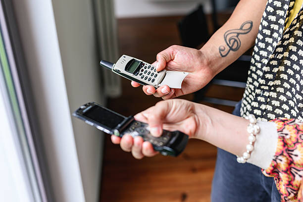 young hands tapping at retro flip phones