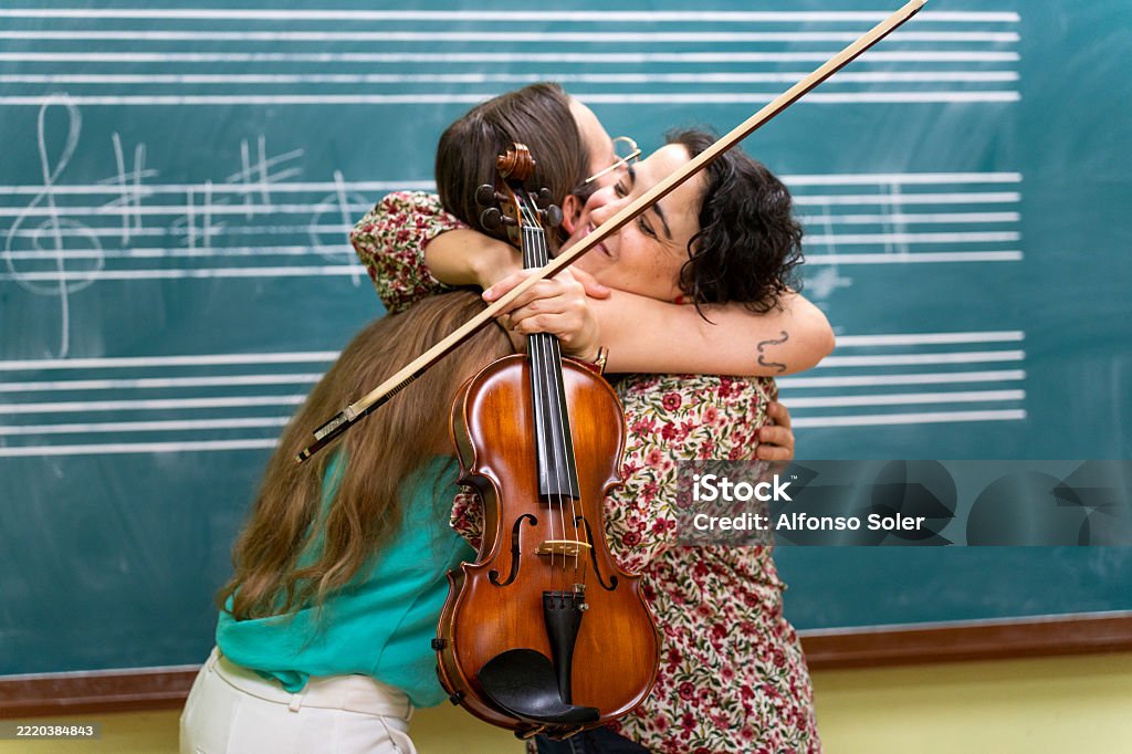 Playing Biola Music Students Hugging After Playing Viola In Classroom Stock Photo ...