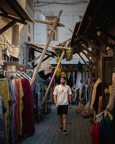 istock Man walking through traditional market alley. 2220385192