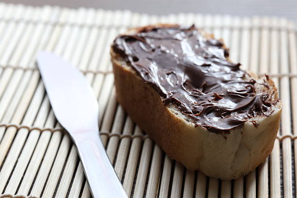 chocolate cream spread on a slice of bread, close up