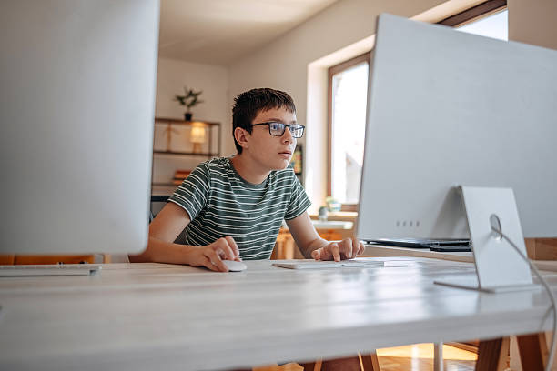 istock Young teenager doing computer crime at home 2220386885