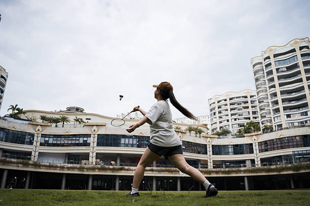 The girl playing badminton outdoors