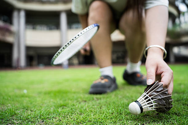 The girl playing badminton outdoors