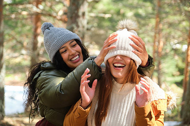istock Two happy young women playing in the forest during wintertime 2220387364