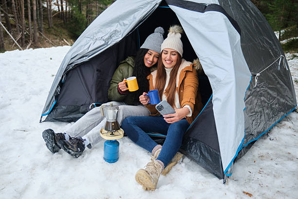 istock Two Young Women Taking Selfie While Camping in the Snow 2220387976