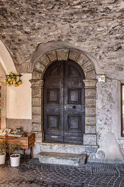 Limone sul Garda, Italy – April 10, 2025: Charming door in an old town building in Limone sul Garda, Lombardy, Italy.