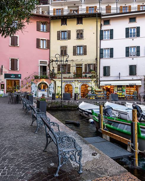 View of a glimpse of Lake Como from a quaint corner of an alley in the historic center of Varenna that directly overlooks the water of Lake. Varenna , Lake Como, Italy