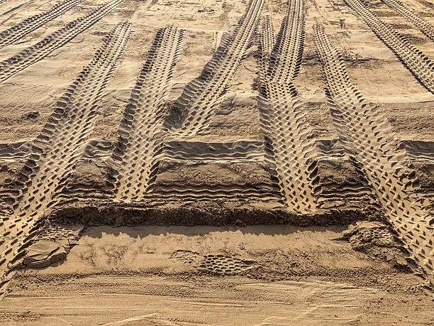 istock Tire tracks on the sand 2220389382