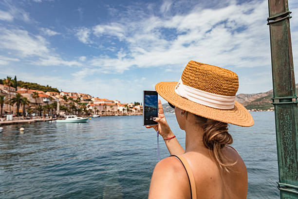 istock Tourist Taking Smartphone Photo on Adriatic Waterfront 2220390528