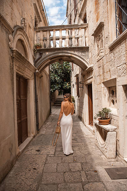 istock Stylish Female Tourist Exploring Old Town Architecture - 2220391395