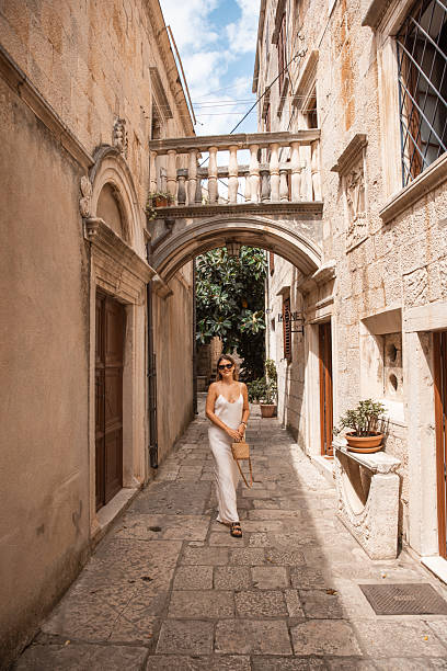 istock Stylish Female Tourist Exploring Old Town Architecture - 2220391525