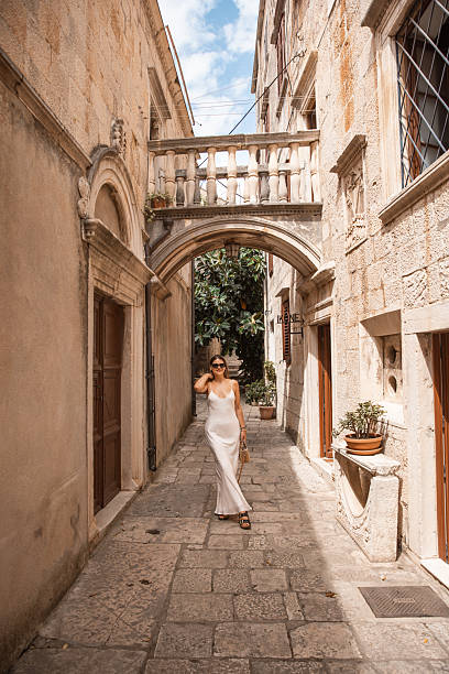 istock Stylish Female Tourist Exploring Old Town Architecture - 2220391670
