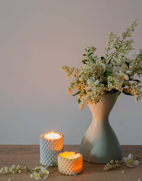 istock white lilac flowers in vase with burning scened candles 2220393188