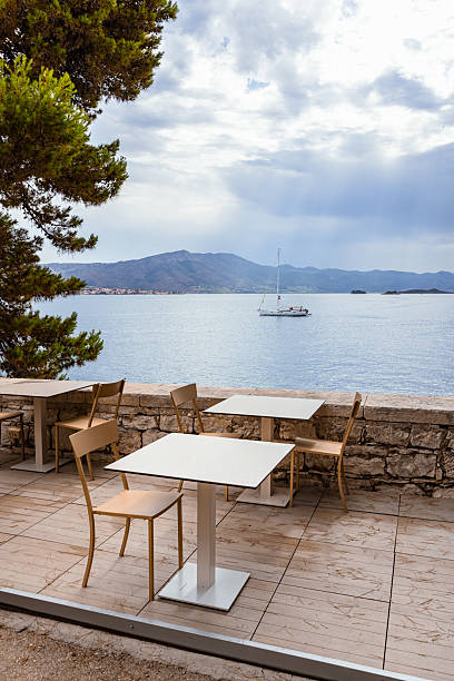 istock Seaside Restaurant Terrace with Sailboat View – Korcula, Croatia 2220393728