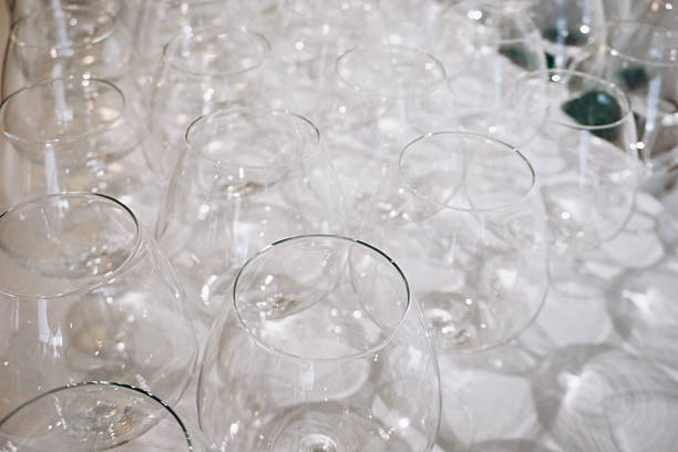 A row of elegant empty wine glasses sparkles in soft focus, creating a refined and festive atmosphere. High quality photo