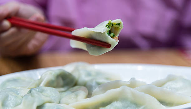 istock Woman hand picked up a dumpling 2220393937