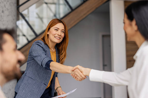 istock Two female leaders shaking hands during the meeting at minimalistic office. 2220395767