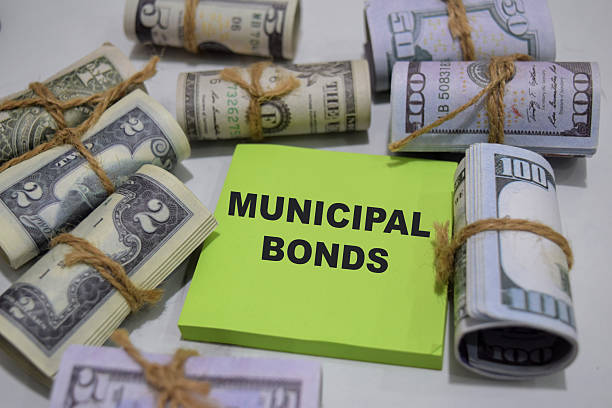 istock Concept of Municipal Bonds write on sticky notes isolated on Wooden Table. 2220398241