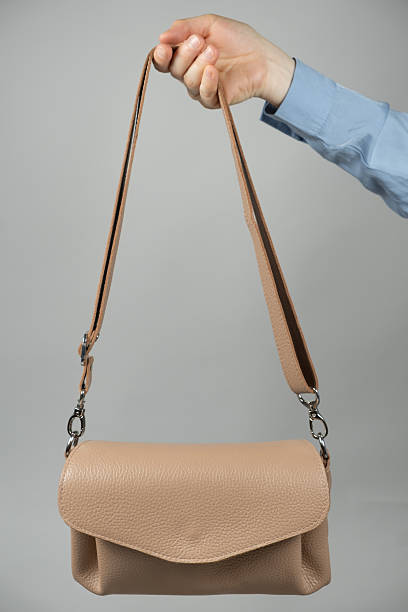 istock Small leather women's handbag in hand 2220400443