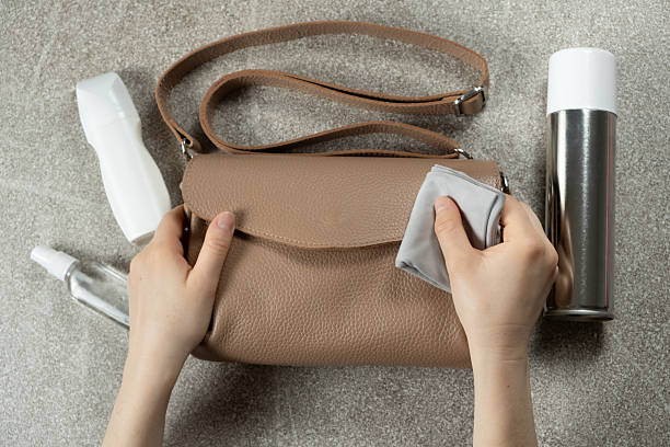 Cleaning a Leather Handbag. Leather Purse Maintenance. Proper Cleaning Tips. stock photo